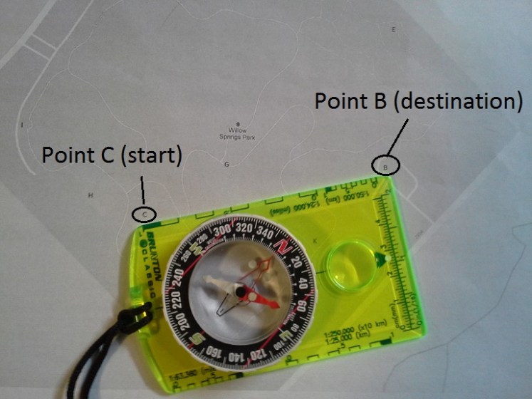 Line the edge of your compass between your start and destination